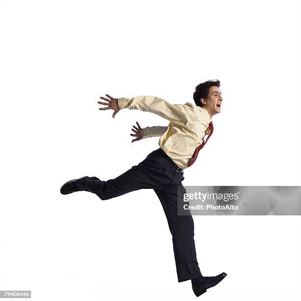 man jumping with arms behind back - running man profile stock pictures, royalty-free photos & images