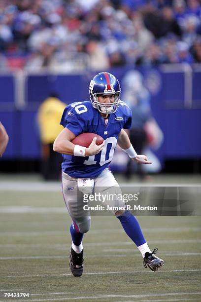 New York Giants quarterback Eli Manning is unable to fins an open receiver and runs for a few yards during Philadelphia Eagles Lost to the New York...