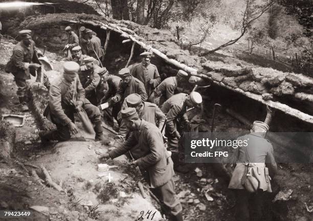 German troops salvaging belongings left behind in a trench after a hasty withdrawal by Russian forces on the Eastern Front during World War I, circa...