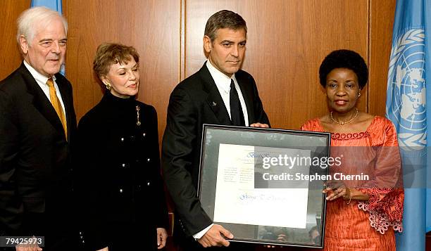 New UN Messenger of Peace, George Clooney receives a certificate designating him Messenger of Peace from Deputy Scretary-General Dr. Asha-Rose Migiro...