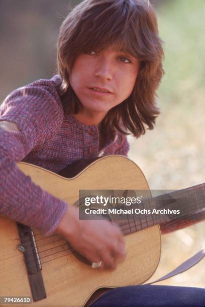 Teen idol David Cassidy aka Keith Partridge, the lead singer of "The Partridge Family", poses for a portrait with an acoustic guitar in September...