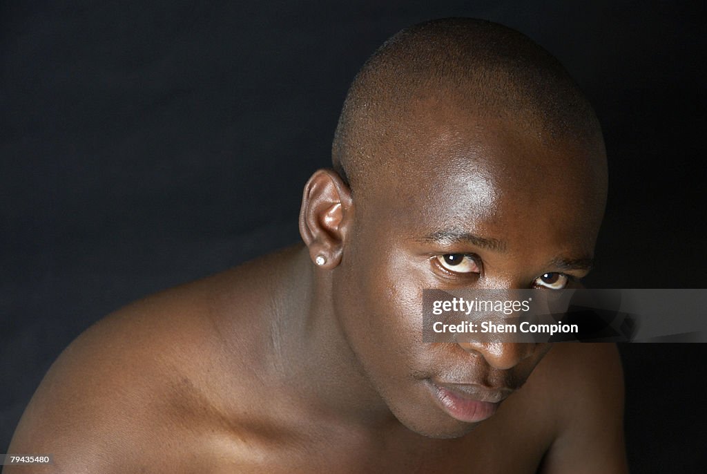 Portrait of a man wearing an earring, Studio Shot