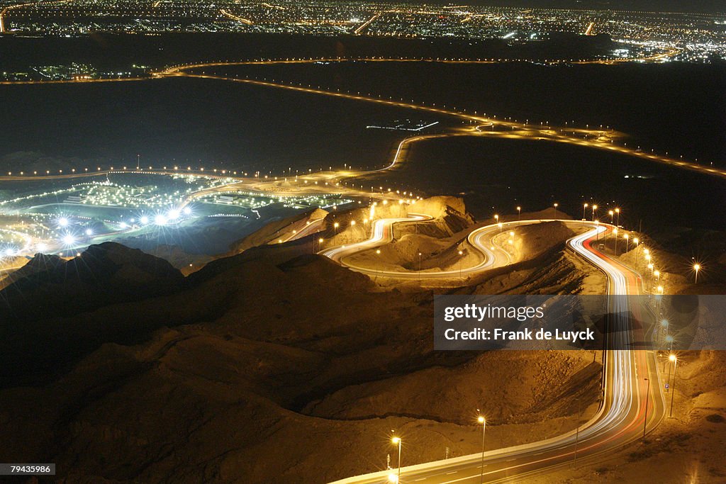 Winding road towards Al Ain city, as seen from Jebel Hafeet. Jebel Hafeet, Al Ain, Abu Dhabi, United Arab Emirates
