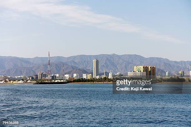 skyline of the growing fujairah's town which helps make up the united arab emirates. - fujairah stock pictures, royalty-free photos & images