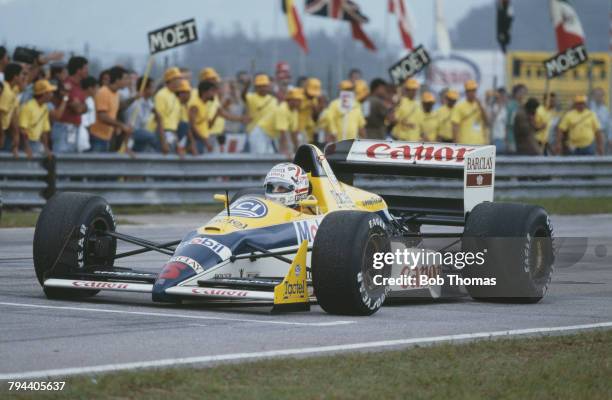 British racing driver Nigel Mansell drives the Canon Williams Williams FW12 Judd CV 3.5 V8 in the 1988 Brazilian Grand Prix at the Autodromo...