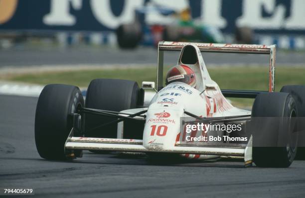 Italian racing driver Alex Caffi drives the Footwork Arrows Racing Arrows A11B Cosworth V8 to finish in 7th place in the 1990 British Grand Prix at...