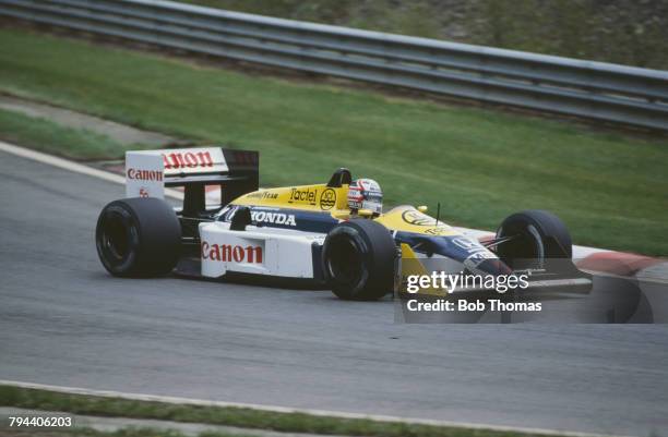 British racing driver Nigel Mansell drives the Canon Williams Honda Williams FW11B Honda RA167E 1.5 V6t in the 1987 Belgian Grand Prix at the Circuit...