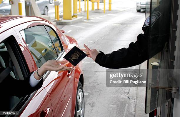 Driver hands their proof of citizenship to a U.S. Customs & Border Protection agent at the Detroit/Windsor Tunnel January 31, 2008 in Detroit,...