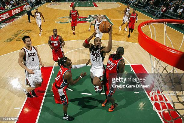 Michael Redd of the Milwaukee Bucks goes to the basket against Jeff McInnis and Jason Richardson of the Charlotte Bobcats during the game at the...