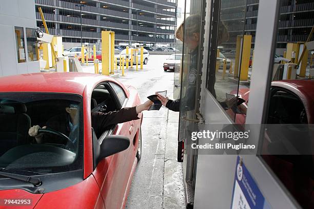 Driver hands his proof of citizenship to a U.S. Customs & Border Protection agent at the Detroit/Windsor Tunnel January 31, 2008 in Detroit,...