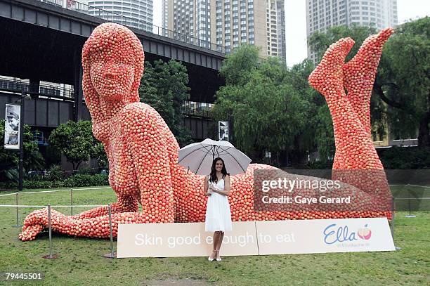 Actress Jolene Anderson poses next to a 12 metre high sculpture which was modelled on her and made from peaches in Fleet Park on February 1, 2008 in...