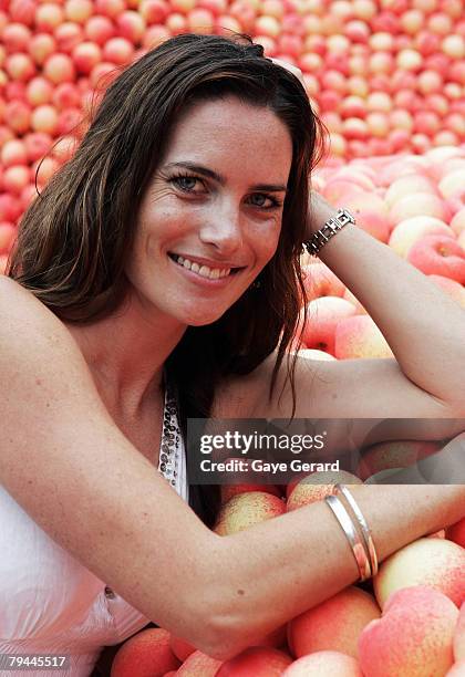 Actress Jolene Anderson poses next to a 12 metre high sculpture which was modelled on her and made from peaches in Fleet Park on February 1, 2008 in...