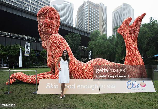 Actress Jolene Anderson poses next to a 12 metre high sculpture which was modelled on her and made from peaches in Fleet Park on February 1, 2008 in...