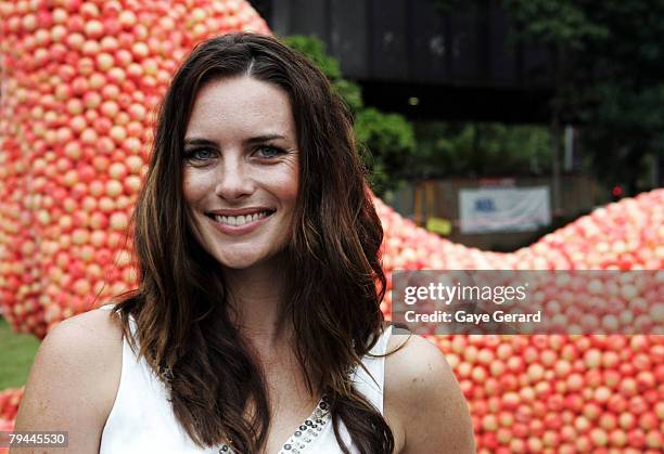 Actress Jolene Anderson poses next to a 12 metre high sculpture which was modelled on her and made from peaches in Fleet Park on February 1, 2008 in...