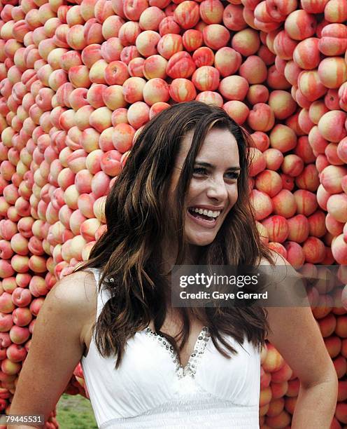 Actress Jolene Anderson poses next to a 12 metre high sculpture which was modelled on her and made from peaches in Fleet Park on February 1, 2008 in...