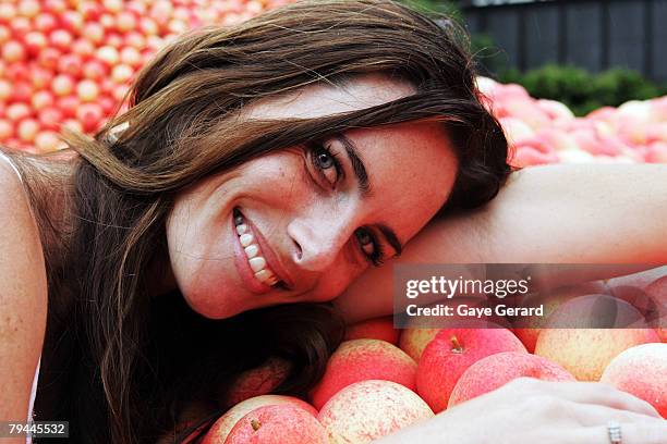 Actress Jolene Anderson poses next to a 12 metre high sculpture which was modelled on her and made from peaches in Fleet Park on February 1, 2008 in...