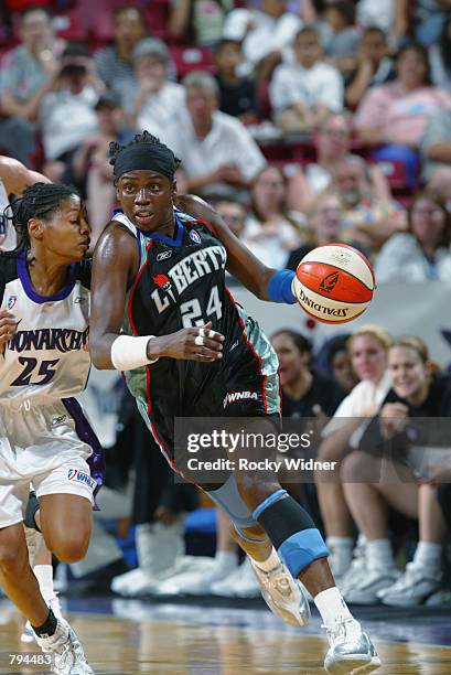 Tari Phillips of the New York Liberty drives around Kedra Holland-Corn of the Sacramento Monarchs during the game at Arco Arena in Sacramento,...