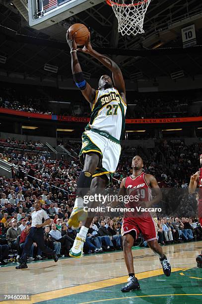 Johan Petro of Seattle SuperSonics goes to the basket past the defense of Damon Jones of the Cleveland Cavaliers at the Key Arena January 31, 2008 in...