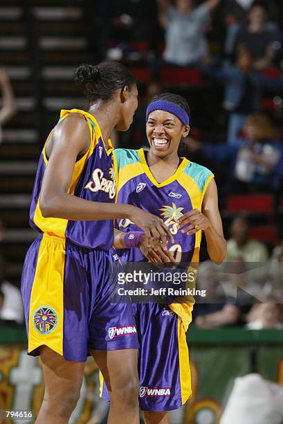 DeLisha Milton and Nicky McCrimmon of the Los Angeles Sparks laugh with each other during the game against the Seattle Storm on June 18, 2002 at Key...