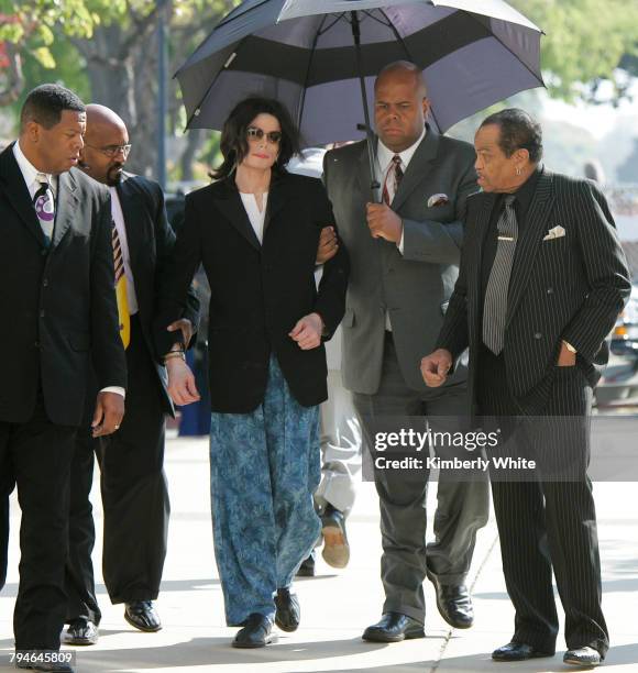 Michael Jackson arrives at a court house wearing pajama bottoms for his child molestation trial next to his father Joe in Santa Maria, California.