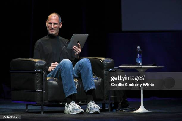 Apple CEO Steve Jobs holds the iPad during the launch of Apple's new tablet computing device in San Francisco.