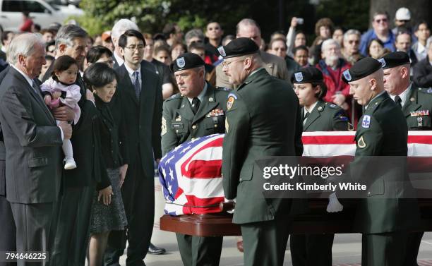 Honor guards carry the casket of Robert T. Matsui, a child of World War II internment camps and Democrat in the U.S. House of Representatives, over...