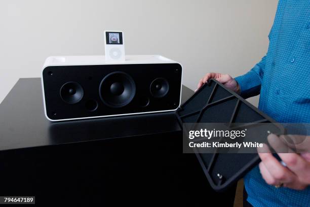 An Apple Computer Inc. Employee takes the cover off the new iPod Hi-Fi stereo system in Cupertino, California.