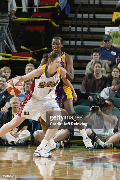 Lauren Jackson of the Seattle Storm moves around DeLisha Milton of the Los Angeles Sparks during the game on June 18, 2002 at Key Arena in Seattle,...