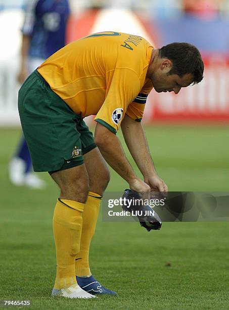 Australian forward Mark Viduka wears his shoe during Australia vs Japan quarter-final match of the Asian Football Cup in Hanoi, 21 July 2007. Japan...
