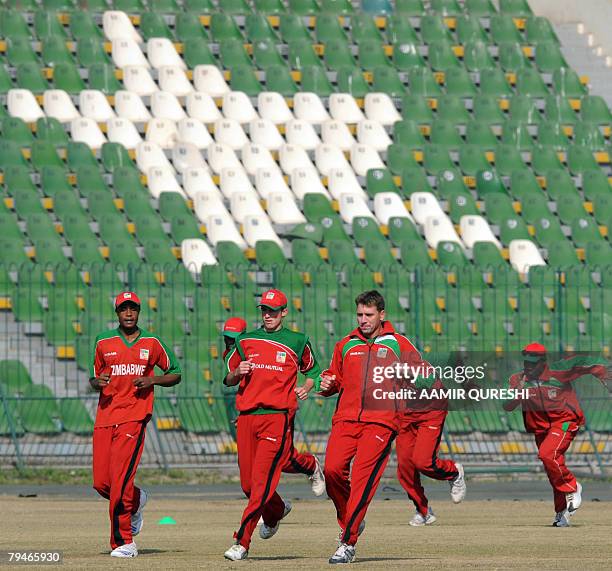 Zimbabwean cricketers warm up during a practice session at the Gaddafi Cricket Stadium in Lahore, 01 February 2008. Pakistani will play the fifth...