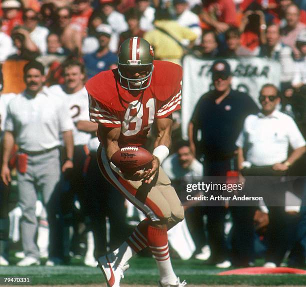 San Francisco tight end Russ Francis cradles the ball during a 26-10 loss to the Chicago Bears on October 13 at Candlestick Park in San Francisco,...