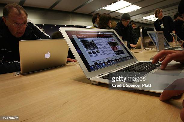 Customers at the midtown fifth avenue Apple Store look at the new MacBook Air on sale beginning today February 1, 2008 in New York City. The Macbook...