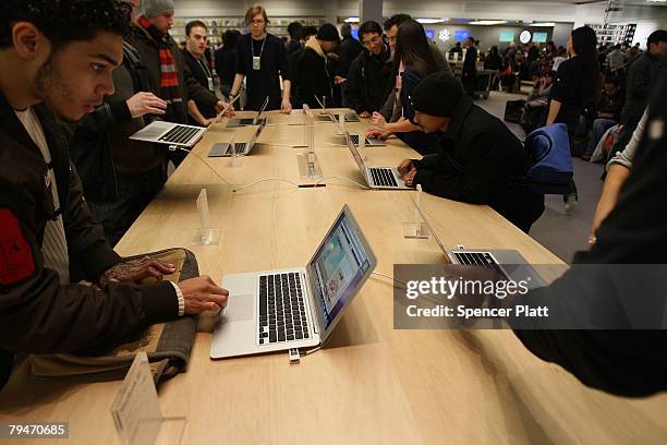 Customers at the midtown fifth avenue Apple Store look at the new MacBook Air on sale beginning today February 1, 2008 in New York City. The Macbook...