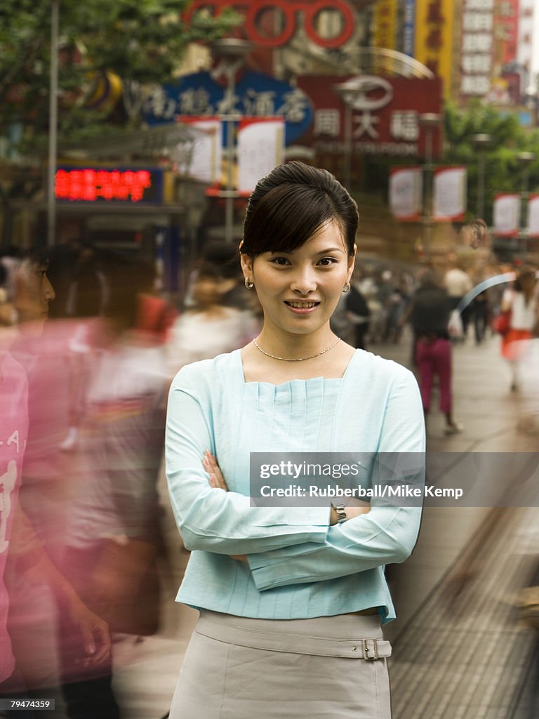 Woman standing on a busy city street