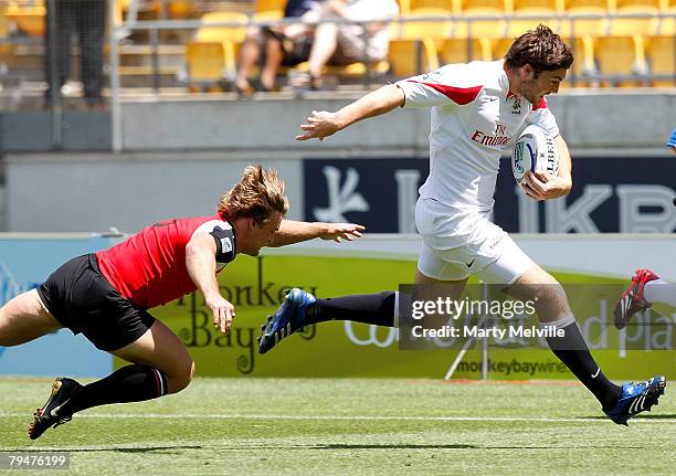 Matt Banahan of England runs out of a tackle by Jordan Kozina of Canada during a Quarter Final Bowl match between England and Canada during the New...