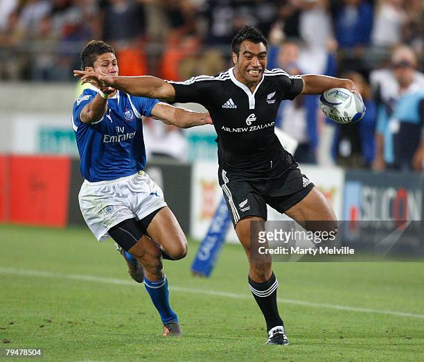 Victor Vito of New Zealand out runs Alatasi Tupou of Samoa during the Cup final match between Samoa and New Zealand during the New Zealand...