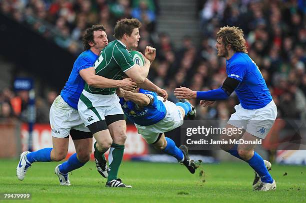 Brian O'Driscoll of Ireland is tackled by Mauro Bergamasco , Andrea Masi and Mirco Bergamasco of Italy during the RBS 6 Nations Championship match...