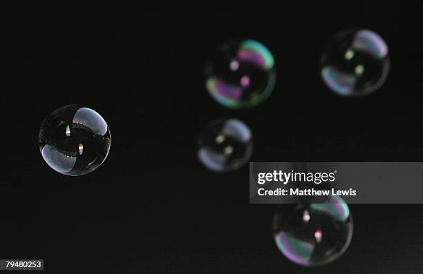 West Ham United fans blow bubbles during the Barclays Premier League match between Wigan Athletic and West Ham United at the JJB Stadium on February...