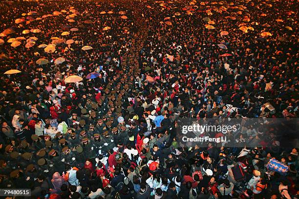 Chinese soldiers keep order among passengers stranded due to heavy snow in the Guangzhou Railway Station on February 2, 2008 in Guangzhou of...