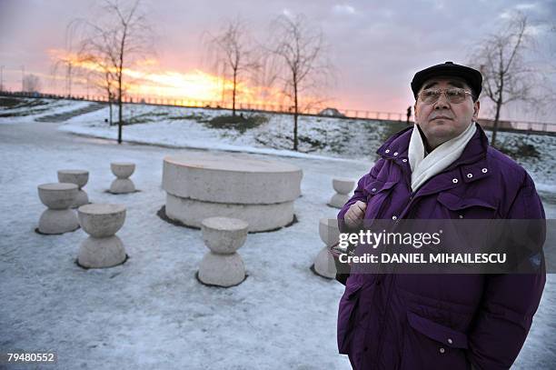 Jewel maker Ovidiu Paraianu poses, 23 January 2008, in Bucharest next to "The Silent table" by Constantin Brancusi, 23 January 2008 in Targu Jiu,...