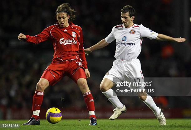 Sunderland's Irish midfielder Liam Miller challenges Liverpool's Brazilian midfielder Lucas during their English Premiership football match at...