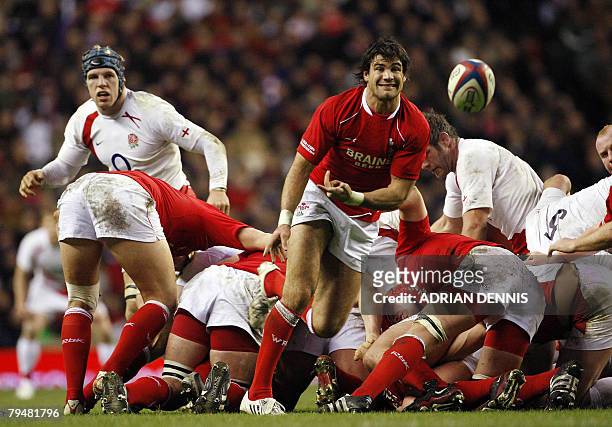 Wales' scrum-half Mike Phillips passes the ball from the scrum against England during the Six Nations rugby union international game at Twickenham,...