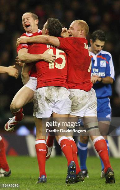 Shane Williams, Lee Byrne and Martyn Williams celebrate their team's victory as the final whistle blows during the RBS Six Nations Championship match...