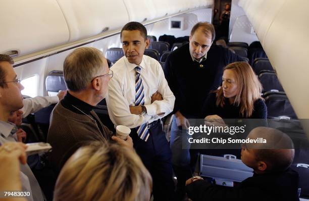 Democratic presidential hopeful Sen. Barack Obama and his chief political advisor David Axelrod talk with reporters on the campaign plane while en...