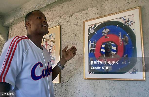 Cuban former boxer Felix Savon stands next to his art works on February 2, 2008 during his first exhibition, in a private house in Calabazar...