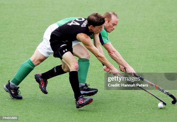 Gareth Brooks of New Zealand competes with Patrick Brown of Ireland during the Olympic Qualifying Hockey match between New Zealand and Ireland at...