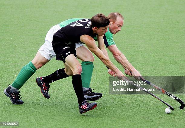 Gareth Brooks of New Zealand competes with Patrick Brown of Ireland during the Olympic Qualifying Hockey match between New Zealand and Ireland at...