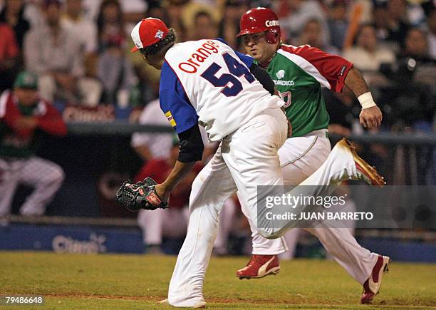 Pitcher Alfredo Simon of Aguilas del Cibao from the Dominican Republic runs over to tag out Agustin Murillo of Yaquis from Mexico during their...