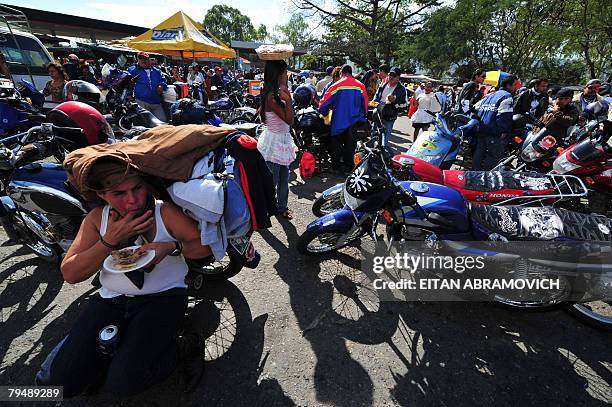 Riders taking part in the motorcycle caravan known as "La Caravana del Zorro" stop for food in El Rancho, 80 km east of Guatemala City on February 2,...