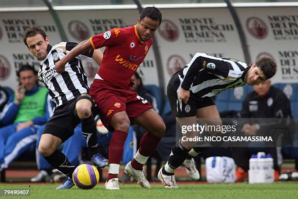 Amantino Mancini of Roma is flanked by Lucas Jarolim and Luca Rossettini of Siena during their seria A soccer match at Artemio Franchi stadium in...